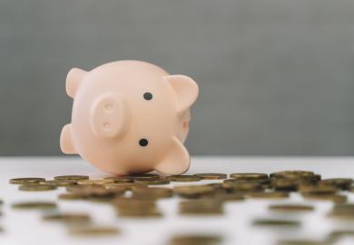 Empty piggy bank lying on copper coins